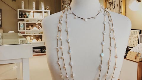 13 secrets necklaces displayed