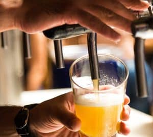 Best Happy Hours in Savannah. a bartender pouring a draft beer