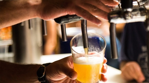 Best Happy Hours in Savannah. a bartender pouring a draft beer