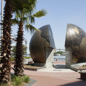 The "A World Apart" monument on River Street. The two halves of the globe are split, representing the conflict of a world divided.