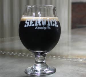 Service Brewing Company. A glass of dark beer