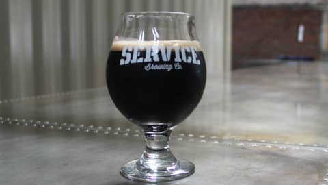 Service Brewing Company. A glass of dark beer