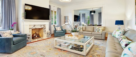 Southern Belle Vacation Rentals. A living room with blue chairs, white sofas