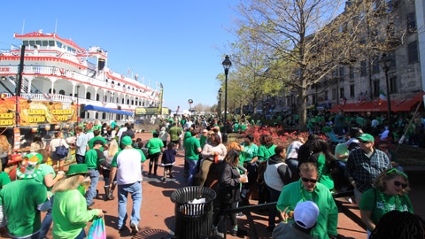 Rousakis Riverfront Plaza. a big crowd in green cloths on a brick promenade
