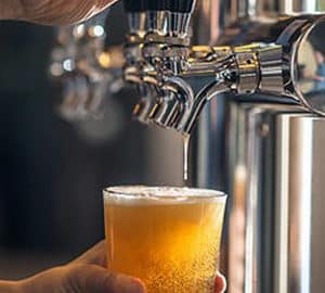 Activities for Beer Enthusiasts. a glass of beer being poured from a tap