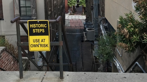The Stone Stairs of Death. Yellow and black sign saying historic steps